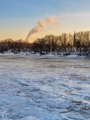 Snowy landscape with a large chimney in the distance