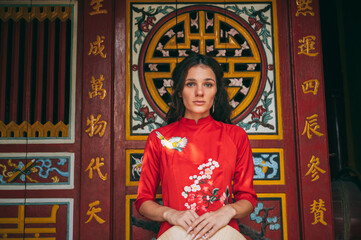 Obraz premium Female traveler in traditional Vietnamese dress travels to temple in southeast asia