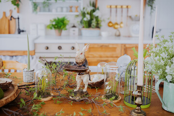 Decorative spring table arrangement featuring a rabbit figurine and plants
