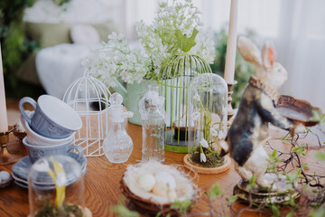 Spring decor arrangement featuring bunny figurines and floral elements