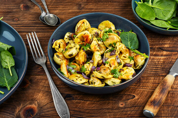 A plate of ravioli filled with a green spinach.
