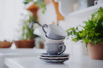 Elegant stacked cups with saucers in a cozy kitchen setting
