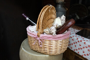red wine bread sausage meat eggs in a basket on a table