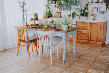 Bright and airy kitchen with rustic wooden table and green decor