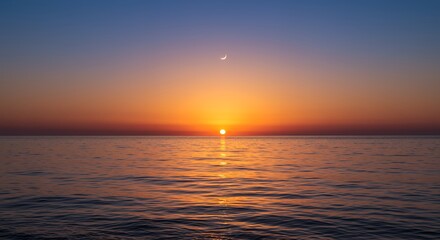 Obraz premium Ocean Sunset and Crescent Moon Reflecting in Calm Water Scenery