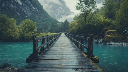Wooden bridge over river, mountain backdrop, rainy day, peaceful nature scene, travel photography
