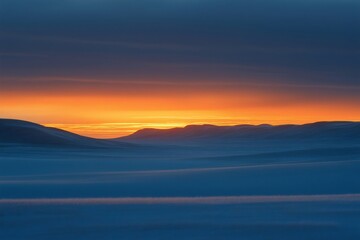 Fototapeta premium Vast expanse of snow covered desert bathed in the warm glow of a vibrant orange sunset, creating a serene and captivating winter scene