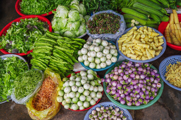Various vegetables and herbs on the market in baskets. Asian vegetables. Vietnam Market