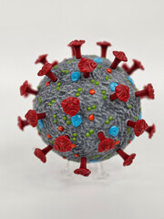 A detailed 3D model showcases the structure of a virus, highlighting red spike proteins