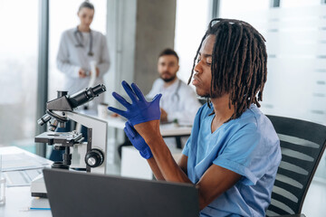 Scientific research by using microscope. Doctors are in the clinic