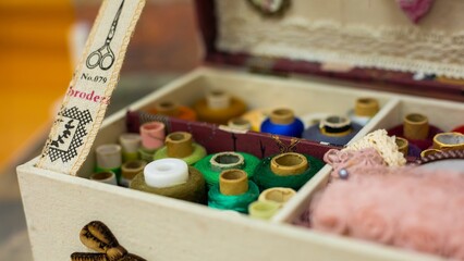 green thread in a sewing kit box