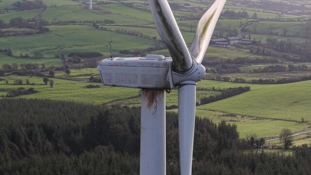 Wind turbines turning over a green landscape in County Cavan, Ireland, promoting clean energy