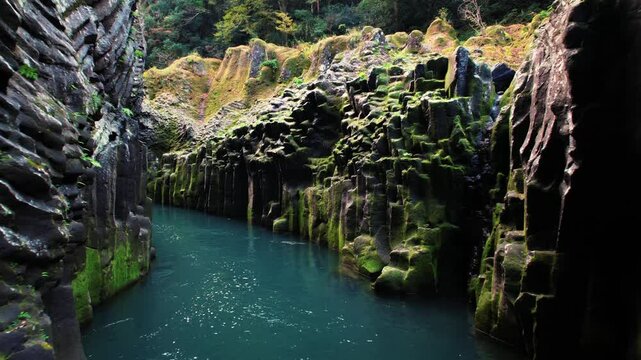 Drone Flys Along River In Between Basalt Columns At Takachiho Gorge In Japan