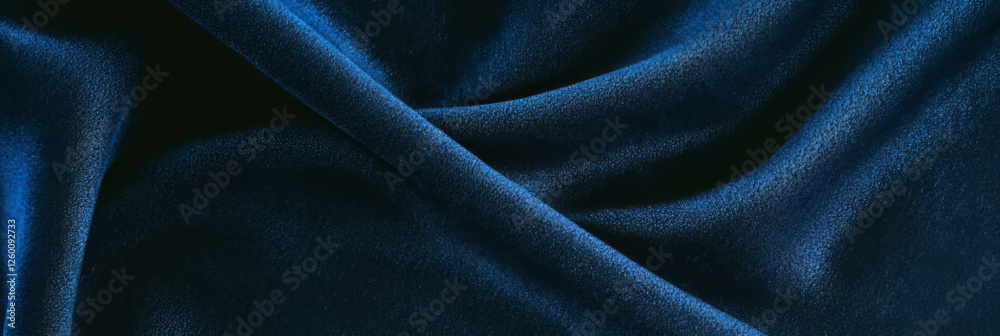 Poster smooth deep blue suede fabric with soft highlights illuminated by side lighting