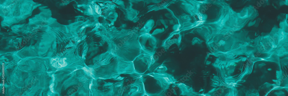 Poster Turquoise water with ripples and shadows creating a textured background