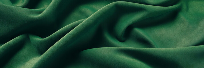 Obraz premium Emerald green suede fabric showcasing fine nap and subtle texture with warm shadows