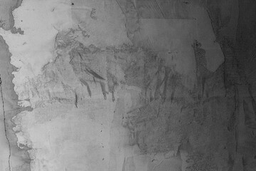 Textured concrete wall reveals abstract shapes and patterns in black and white