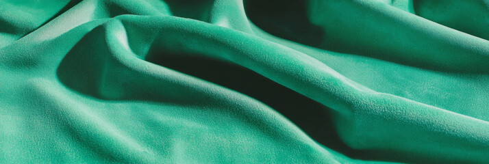 Elegant mint green suede fabric with fine nap and soft texture illuminated by side light