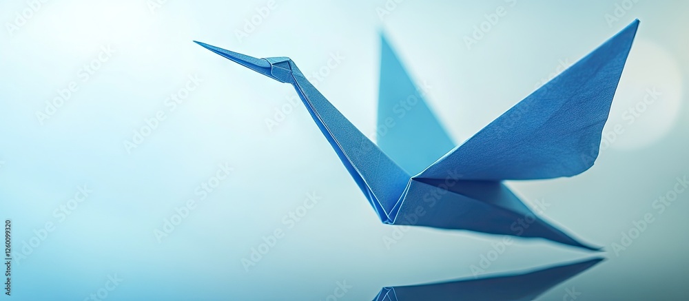 Leinwandbilder elegant blue origami crane positioned on a smooth reflective surface with soft light reflections cre