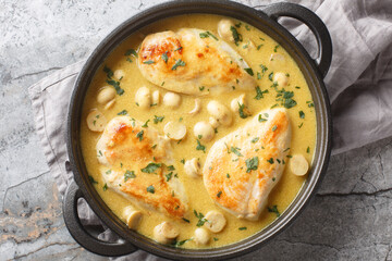 Tasty Chicken Diane with creamy brandy sauce and mushrooms closeup in the skillet on the table. Horizontal top view from above