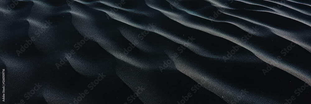 Poster textured black sand dune with ripples and soft lighting during tranquil evening hours