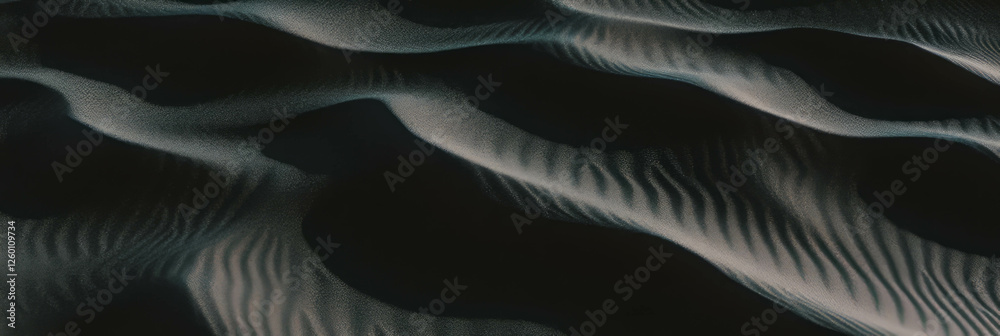Poster Black sand dune with rippled surface showcasing intricate windblown patterns and soft lighting