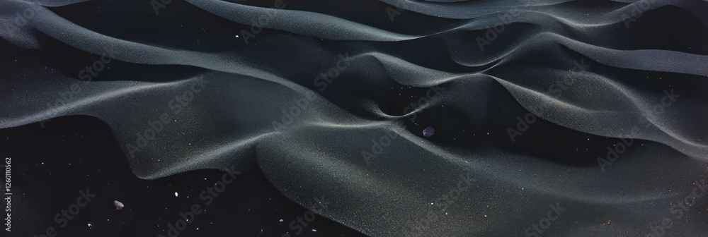 Aufkleber black sand texture with smooth pebbles creating a unique landscape in nature