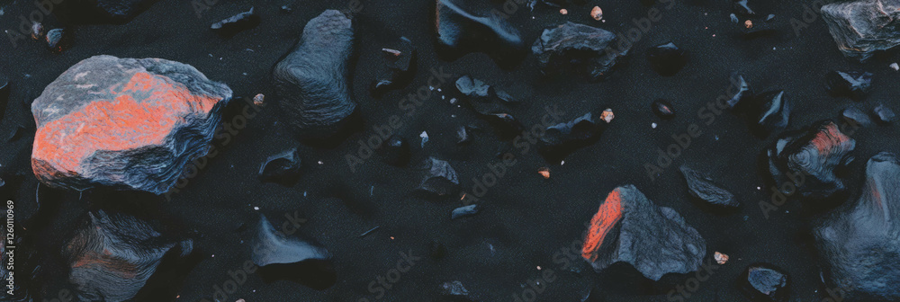 Aufkleber textured black sand contrasted with small lava rocks displaying unique geological features