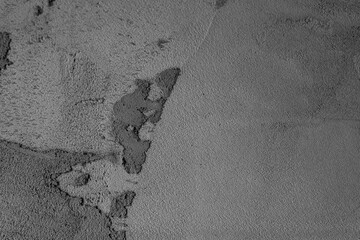 Textured surface showing different shades of gray and uneven patterns