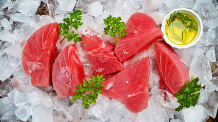 Set of raw tuna steaks on crushed ice. Top view.