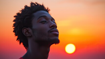 facing my faith young man looking at the sunset blurred background
