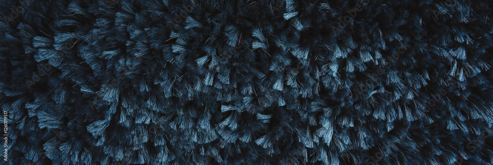 Poster charcoal gray dense frieze carpet showcasing deep shadows and a unique curly pile texture