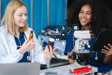 Scientists conducting research in a biotechnology lab, using pipettes and test tubes for medical...