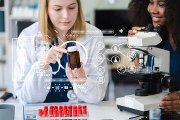 Scientists conducting research in a biotechnology lab, using pipettes and test tubes for medical...