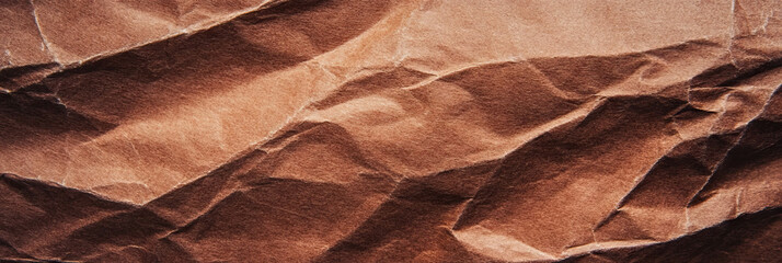 Dark brown recycled paper texture showcasing coarse fibers and rough surface details