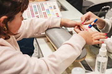 Nail painting session at a salon with vibrant colors and careful application by a skilled technician
