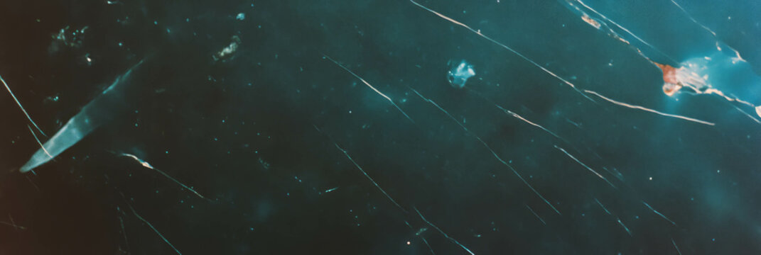 Dust-covered film texture with scratches reveals a vintage aesthetic and low reflectivity