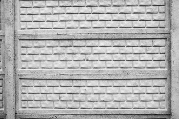 Textured concrete wall with brick pattern in urban environment
