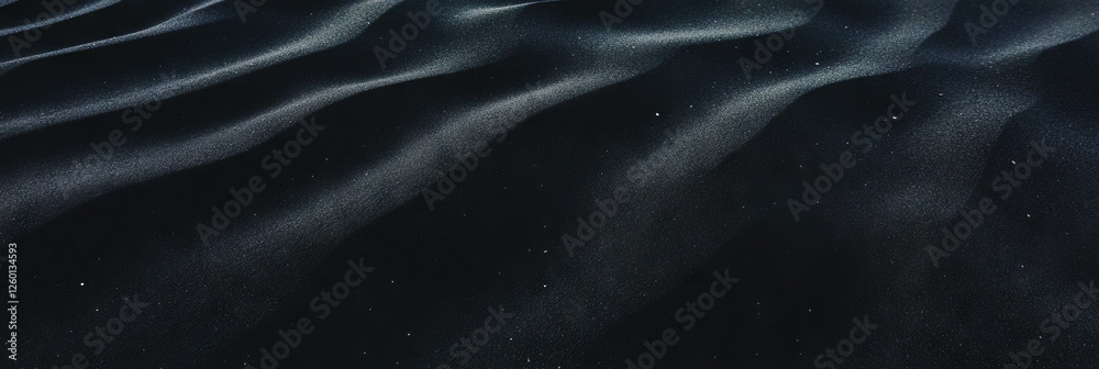 Poster captivating texture of fine black sand with gentle ripples under soft light