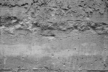 Textured gray concrete surface with imperfections in urban setting