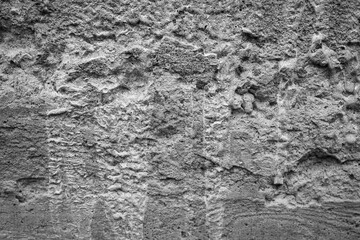 Textured gray wall showcasing unique patterns and structures in urban setting