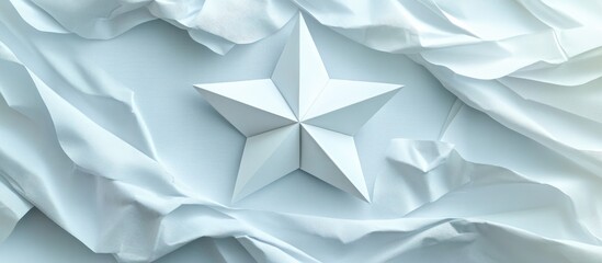 Three-dimensional white origami five-pointed star positioned center against a textured light blue crumpled background creating a serene aesthetic.