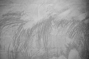 Fototapeta premium Textured gray surface with abstract patterns and brush strokes