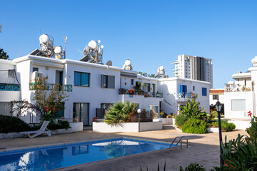 Fototapeta premium White Mediterranean apartments with solar water heaters and swimming pool in Paphos, Cyprus