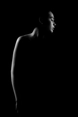 Dramatic Low-Key Portrait of a Woman in Shadows