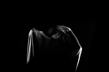 Mysterious Hooded Figure in Dramatic Black and White Lighting