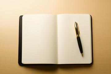 Open notebook and pen placed on a smooth wooden table in a well-lit workspace