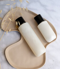 Face cream and tonic in marble tray 