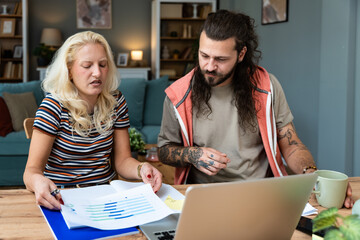 Finance and economy. Young couple, small business owners, working online at home office, preparing for video call for presentation and online coaching. E-commerce man and woman professional occupation