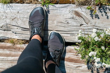 Woman legs with barefoot hiking shoes in the summer mountain 